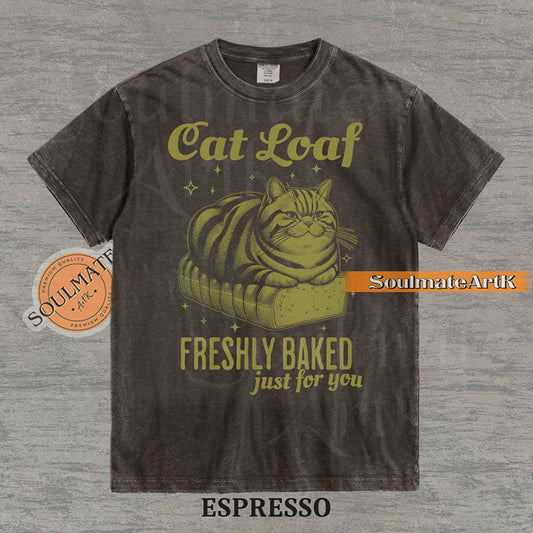Illustration of a tabby cat sitting on a loaf of bread with text reading "Cat Loaf Freshly Baked just for you" on a washed espresso t-shirt.
