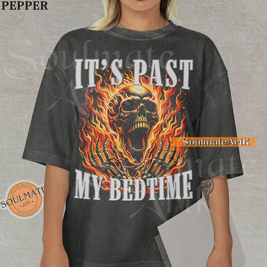 Graphic of a screaming skull in orange flames with bold text reading IT'S PAST MY BEDTIME on a washed pepper t-shirt.
