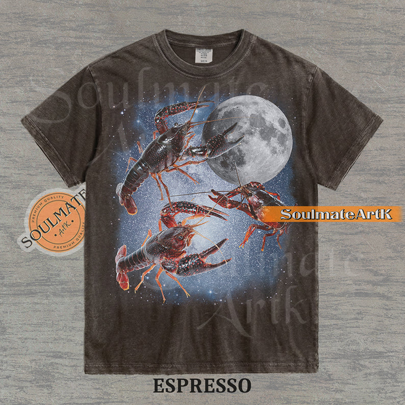 Graphic of three crawfish floating in a starry space nebula next to a full moon on a washed espresso shirt.