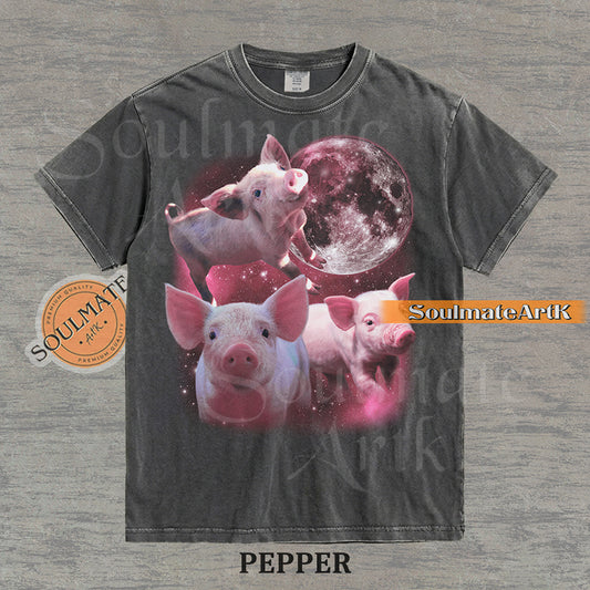 Collage of three pink piglets in front of a glowing pink moon and a starry nebula on a washed pepper shirt.