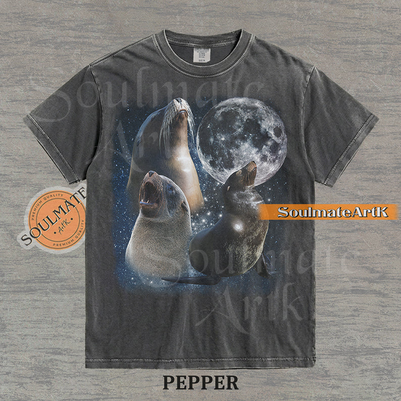 Collage of three sea lions in front of a glowing full moon and a starry night sky on a washed pepper shirt.