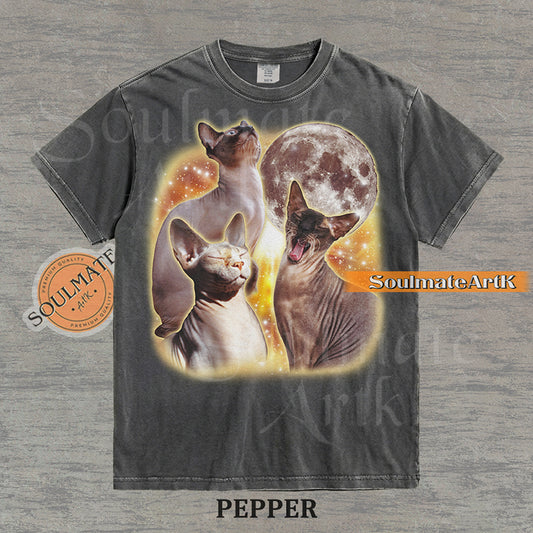 Collage of three Sphynx cats in front of a glowing moon and a golden starry nebula on a washed pepper shirt.