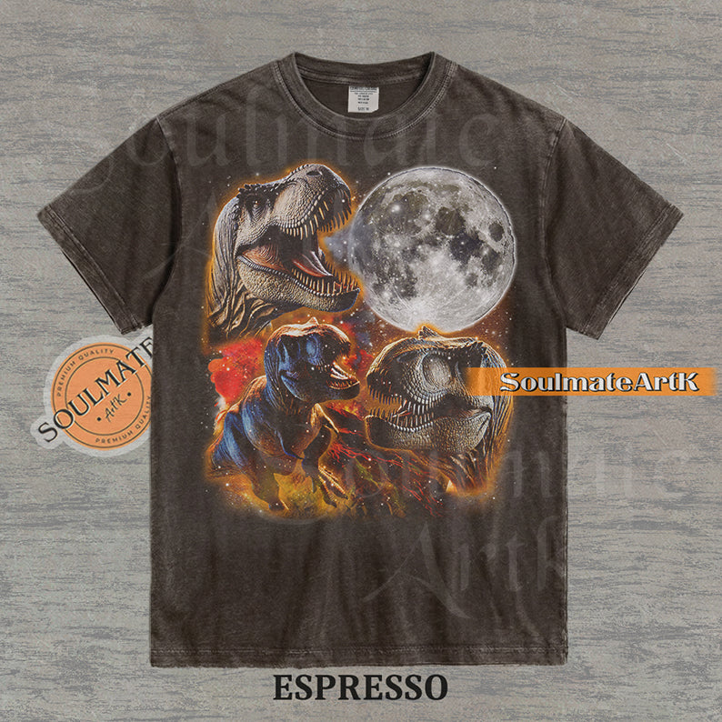 Graphic collage of three T-Rexes next to a large full moon in a starry, colorful space setting on a washed espresso t-shirt.