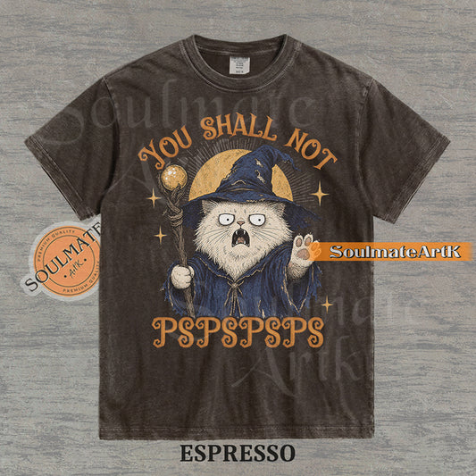 Vintage-style illustration of a white cat dressed as a wizard with a staff and hat, featuring the text You Shall Not PSPSPSPS on a washed Espresso Comfort Colors t-shirt.