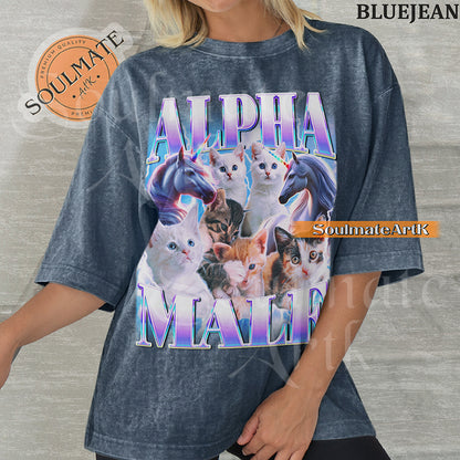 Collage of several cute kittens and two unicorns surrounded by blue lightning with bold purple and blue text reading Alpha Male on a washed bluejean shirt.