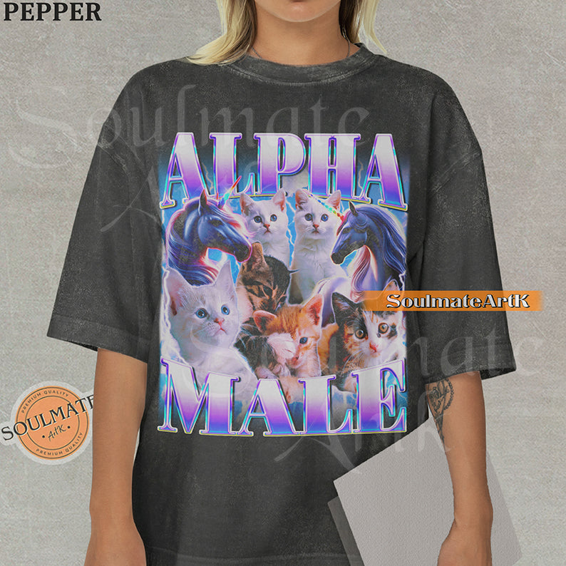 Collage of several cute kittens and two unicorns surrounded by blue lightning with bold purple and blue text reading Alpha Male on a washed pepper shirt.