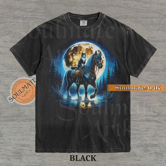 Detailed illustration of a cat sitting on a horse's saddle wading through a stream under a large full moon on a washed black t-shirt.