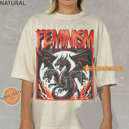Illustration of a multi-headed red and black dragon in a framed graphic with bold red text reading Feminism on a natural shirt.