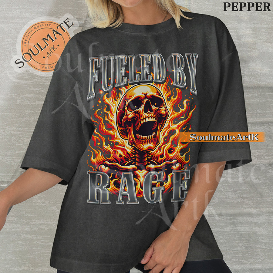 Graphic of a screaming skull engulfed in orange flames with bold chrome 3D text reading FUELED BY RAGE on a washed pepper shirt.