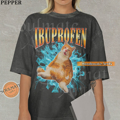 Orange tabby cat with a confused expression surrounded by blue lightning with bold orange gradient text reading Ibuprofen on a washed pepper shirt.