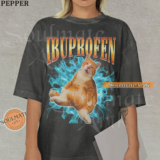 Orange tabby cat with a confused expression surrounded by blue lightning with bold orange gradient text reading Ibuprofen on a washed pepper shirt.