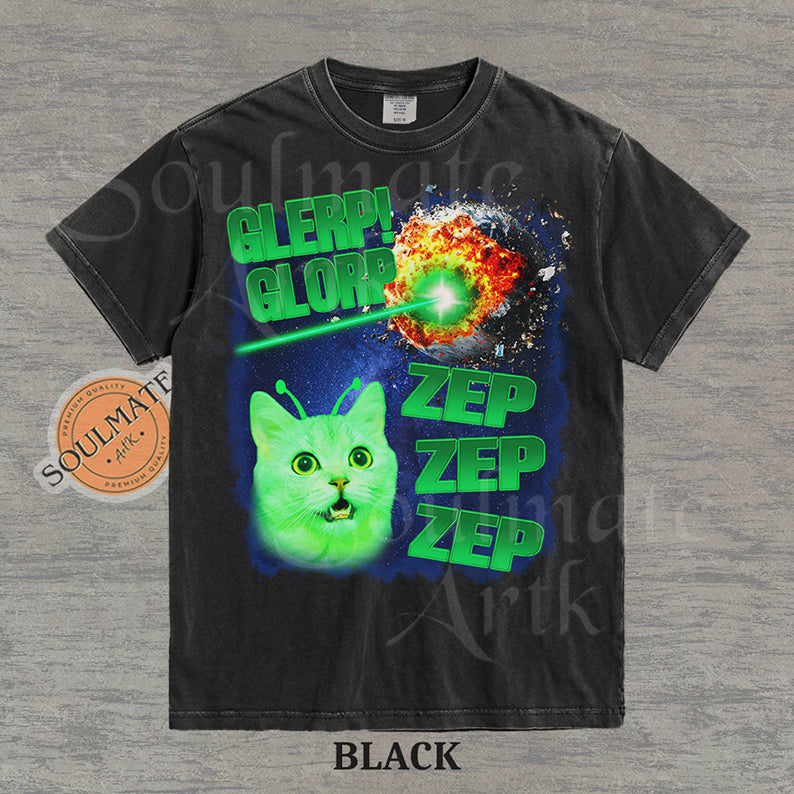 Graphic of a glowing green cat with antennae in space next to an exploding planet and text reading Glerp Glorp Zep Zep Zep on a washed black shirt.