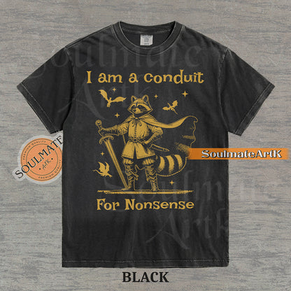 Illustration of a raccoon in knight armor with a cape and sword surrounded by dragons and the text "I am a conduit For Nonsense" on a washed black t-shirt.
