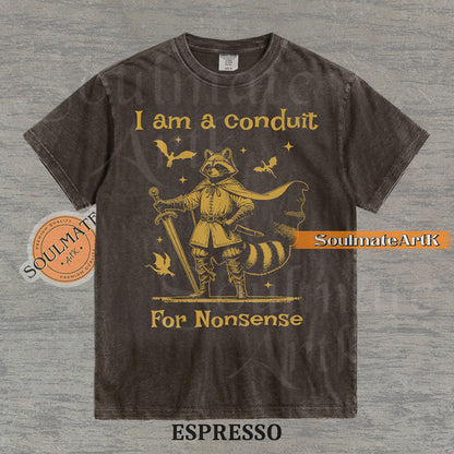 Illustration of a raccoon in knight armor with a cape and sword surrounded by dragons and the text "I am a conduit For Nonsense" on a washed espresso t-shirt.