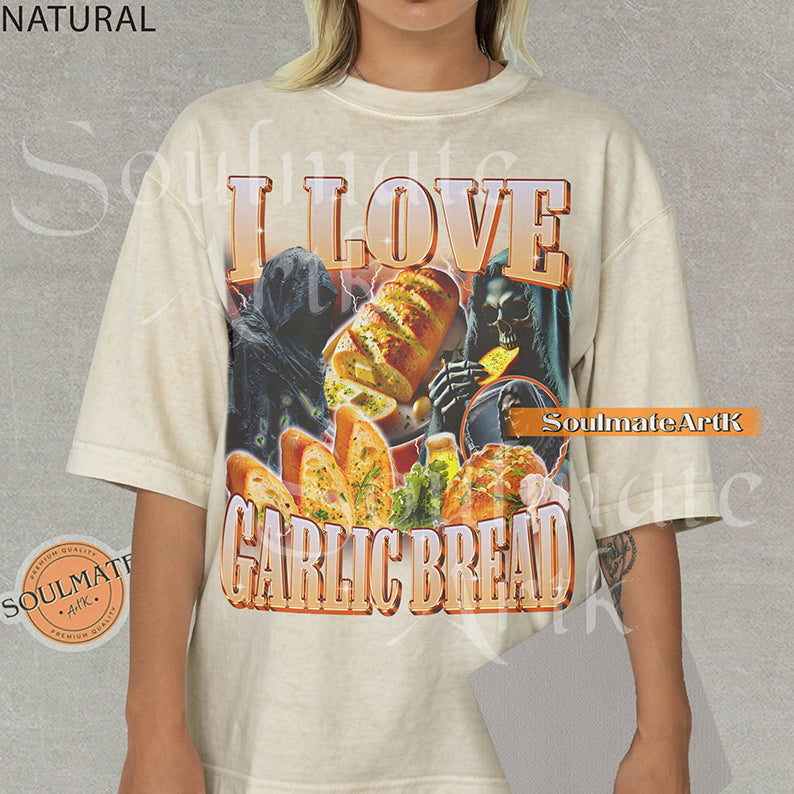 Graphic collage of hooded skeletons and reapers with golden garlic bread and lightning with bold text reading I LOVE GARLIC BREAD on a natural/ivory shirt.