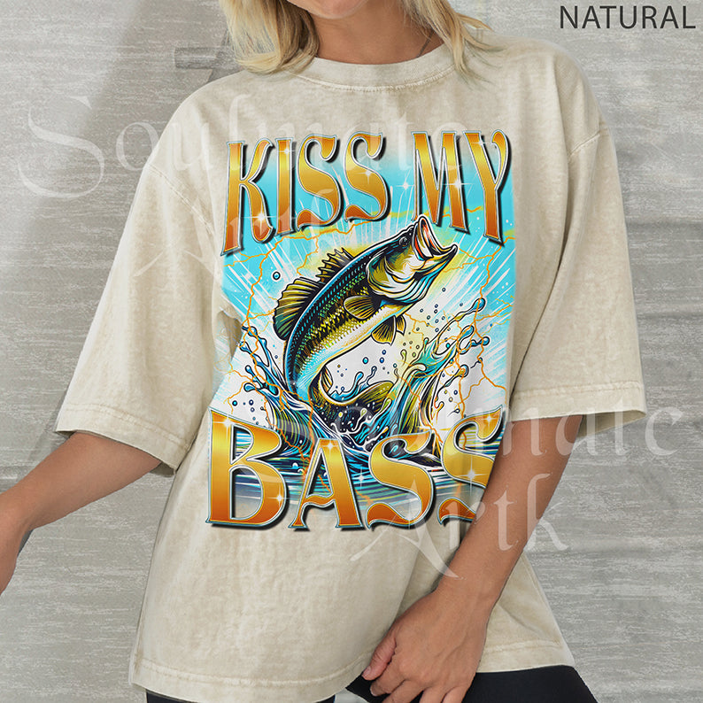 Graphic of a bass fish leaping out of water with golden lightning and bold text reading KISS MY BASS on natural shirt.