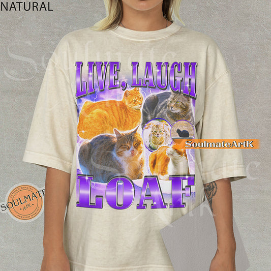 Collage of several cats sitting in loaf positions surrounded by purple lightning with bold purple text reading Live Laugh Loaf on a natural beige shirt.