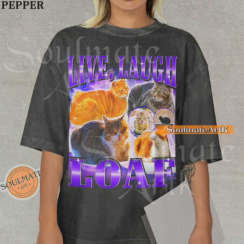 Collage of several cats sitting in loaf positions surrounded by purple lightning with bold purple text reading Live Laugh Loaf on a pepper shirt.