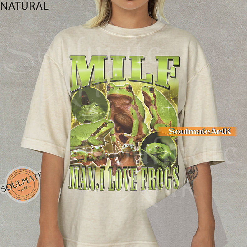 Vintage-style collage of green frogs with lightning effects and bold metallic text reading MILF Man I Love Frogs on a washed natural t-shirt.