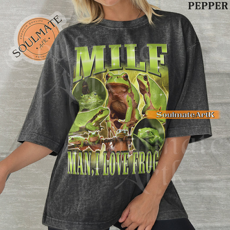 Vintage-style collage of green frogs with lightning effects and bold metallic text reading MILF Man I Love Frogs on a washed pepper t-shirt.