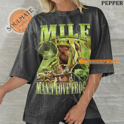 Vintage-style collage of green frogs with lightning effects and bold metallic text reading MILF Man I Love Frogs on a washed pepper t-shirt.