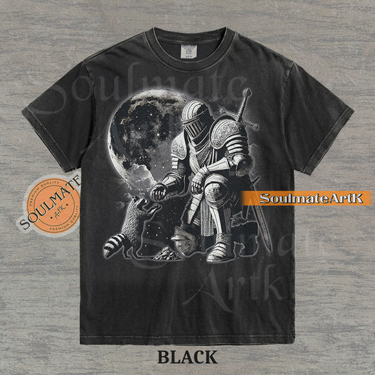 Detailed illustration of a kneeling medieval knight petting a raccoon in front of a giant moon on a washed black shirt.