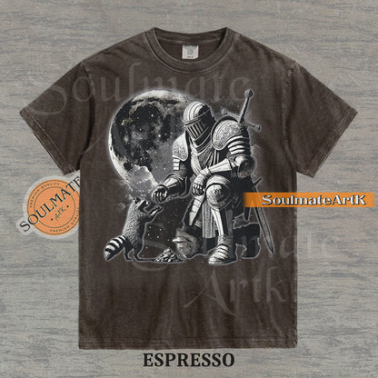 Detailed illustration of a kneeling medieval knight petting a raccoon in front of a giant moon on a washed espresso shirt.