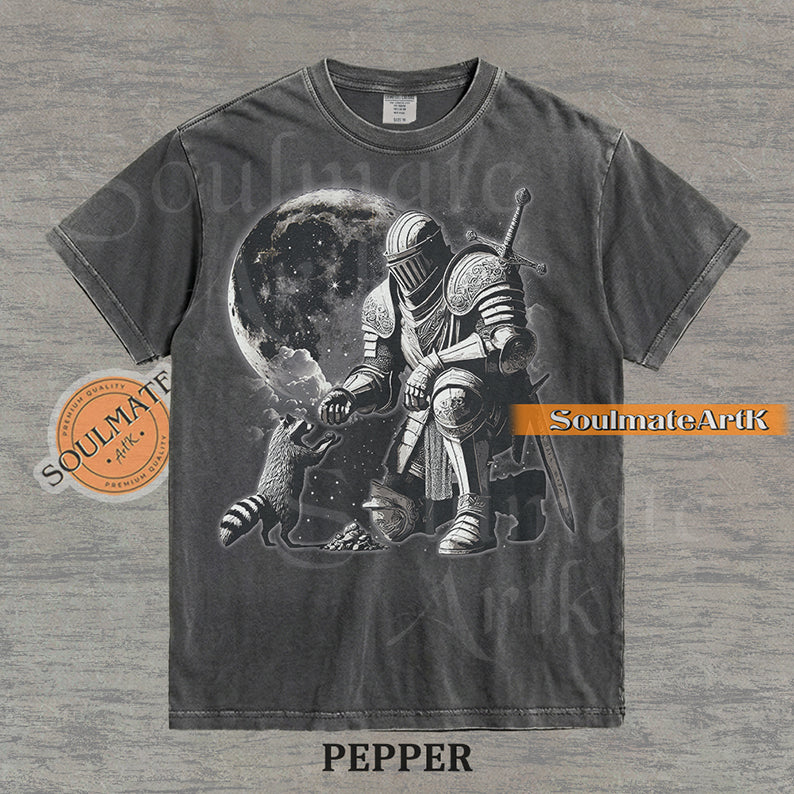 Detailed illustration of a kneeling medieval knight petting a raccoon in front of a giant moon on a washed pepper shirt.