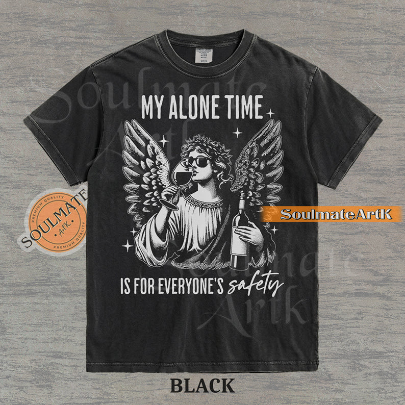 Vintage-style engraving of an angel wearing sunglasses and holding a wine bottle/glass with text reading My Alone Time Is For Everyone's Safety on a washed black t-shirt.