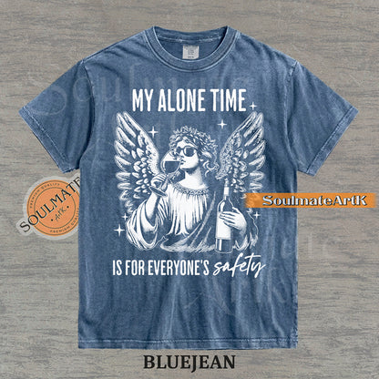 Vintage-style engraving of an angel wearing sunglasses and holding a wine bottle/glass with text reading My Alone Time Is For Everyone's Safety on a washed bluejean t-shirt.