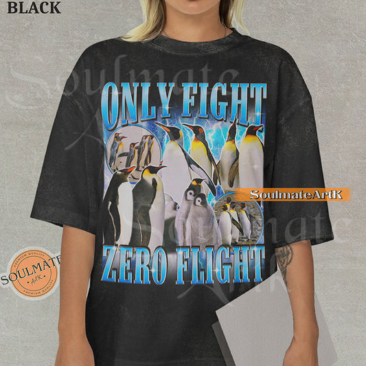 Graphic collage of emperor penguins and chicks with blue lightning and bold metallic text reading ONLY FIGHT ZERO FLIGHT on a washed black t-shirt.