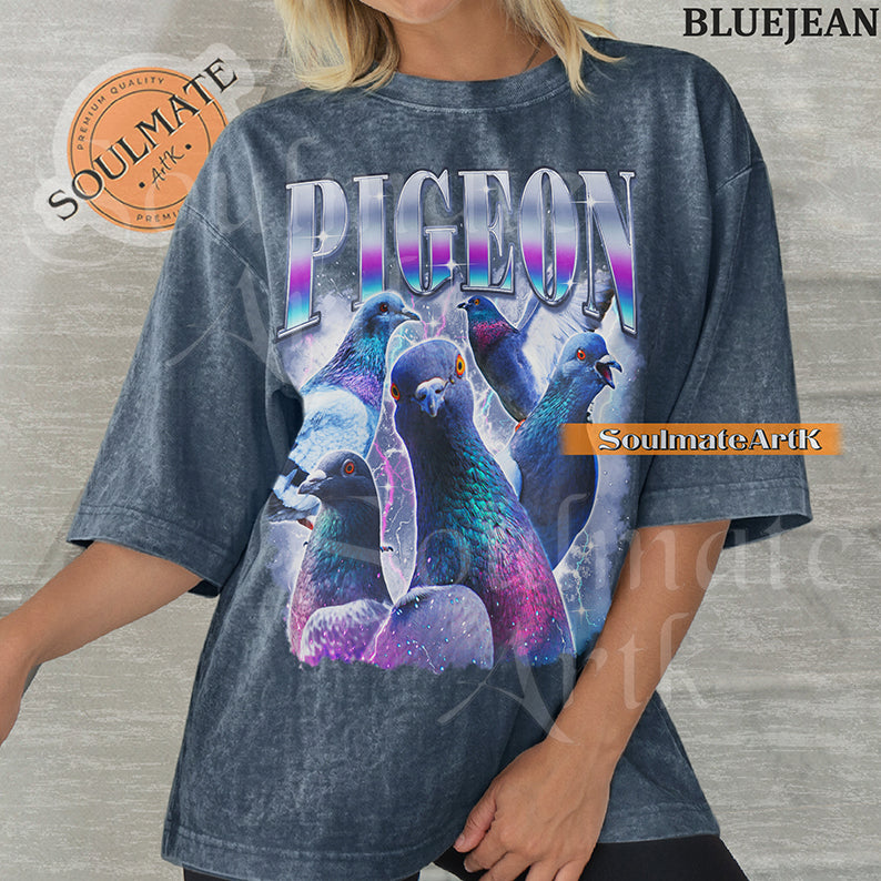 Collage of several pigeons with iridescent feathers surrounded by purple lightning and clouds with bold gradient text reading PIGEON on a washed bluejean shirt.