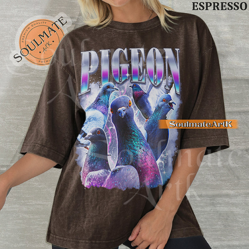 Collage of several pigeons with iridescent feathers surrounded by purple lightning and clouds with bold gradient text reading PIGEON on a washed espresso shirt.