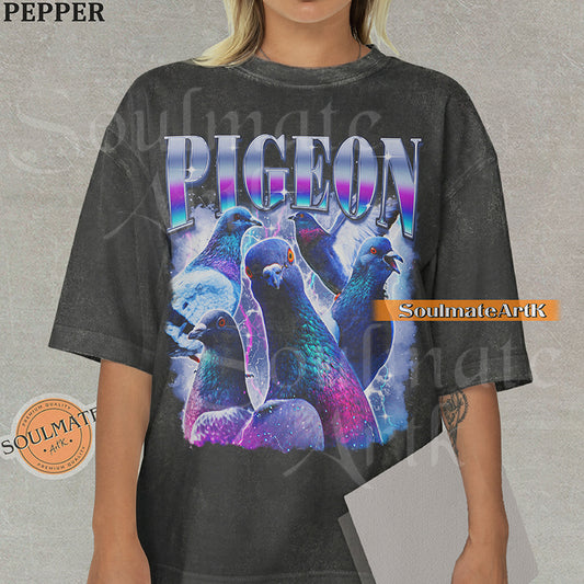 Collage of several pigeons with iridescent feathers surrounded by purple lightning and clouds with bold gradient text reading PIGEON on a washed pepper shirt.