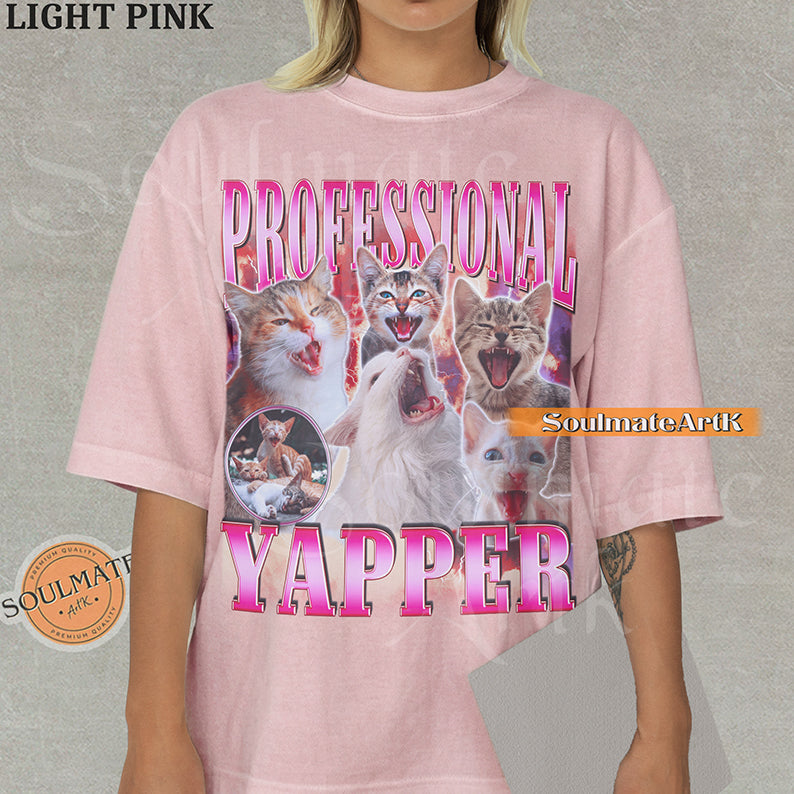 Maximalist vintage-style graphic of multiple kittens meowing with red lightning and pink metallic text reading Professional Yapper on a Light Pink Comfort Colors t-shirt.