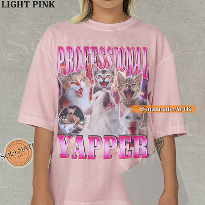 Maximalist vintage-style graphic of multiple kittens meowing with red lightning and pink metallic text reading Professional Yapper on a Light Pink Comfort Colors t-shirt.