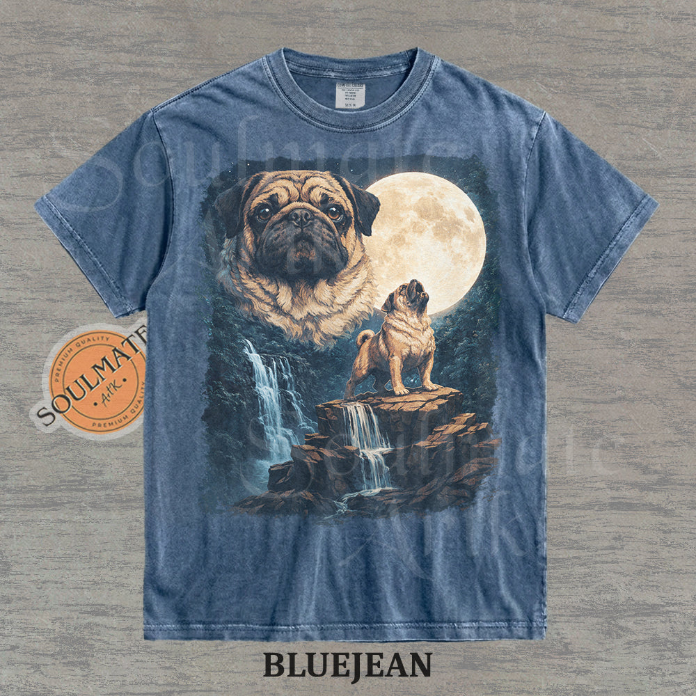 Graphic of pugs in a moonlit mountain landscape with a waterfall on a washed bluejean shirt.