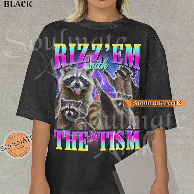 Graphic collage of multiple raccoons over a neon city with bold rainbow text reading RIZZ 'EM WITH THE 'TISM on a washed black shirt.