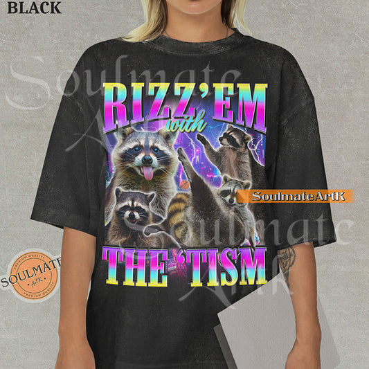 Graphic collage of multiple raccoons over a neon city with bold rainbow text reading RIZZ 'EM WITH THE 'TISM on a washed black shirt.
