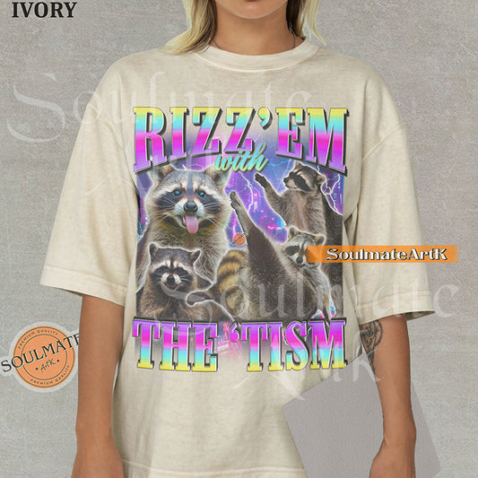 Graphic collage of multiple raccoons over a neon city with bold rainbow text reading RIZZ 'EM WITH THE 'TISM on a natural shirt.