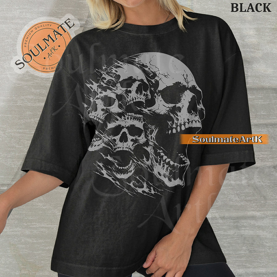 Graphic featuring three detailed screaming skulls in a monochrome illustrative style on a washed black t-shirt.