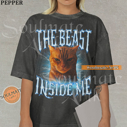 Graphic of an intense orange cat surrounded by blue lightning with bold metallic text reading THE BEAST INSIDE ME on a washed pepper shirt.