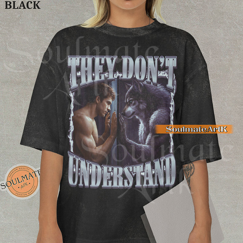 Cinematic graphic of a shirtless man and a wolf facing each other through a window with bold silver text reading They Don't Understand on a washed black shirt.