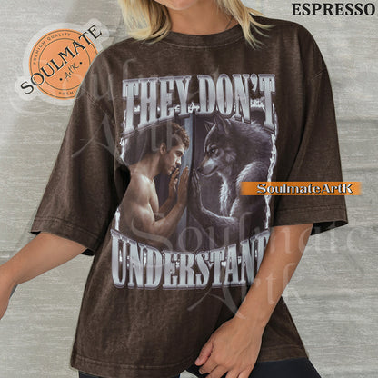 Cinematic graphic of a shirtless man and a wolf facing each other through a window with bold silver text reading They Don't Understand on a washed espresso shirt.