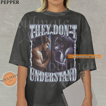 Cinematic graphic of a shirtless man and a wolf facing each other through a window with bold silver text reading They Don't Understand on a washed peper shirt.