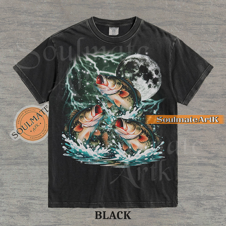 Collage of three bass fish jumping out of water in front of a glowing moon and lightning on a washed black shirt.