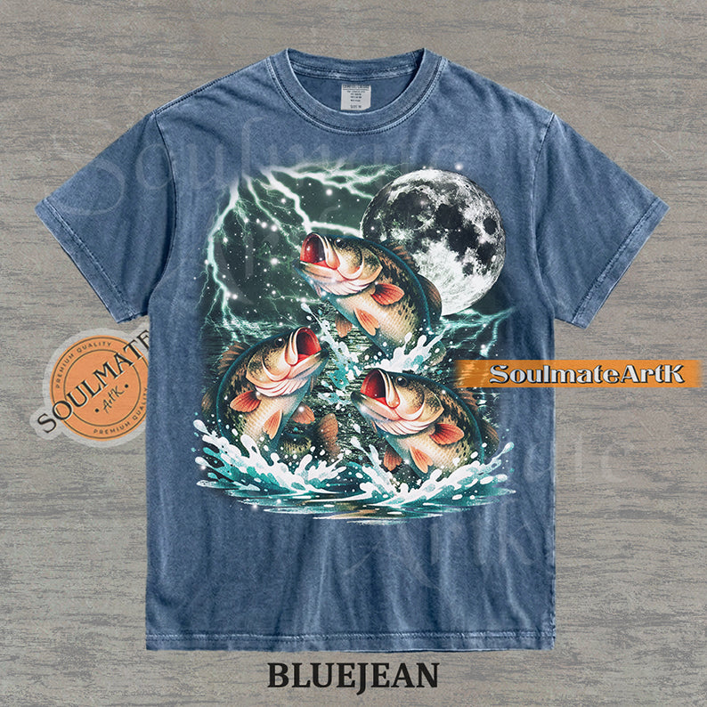 Collage of three bass fish jumping out of water in front of a glowing moon and lightning on a washed bluejean shirt.