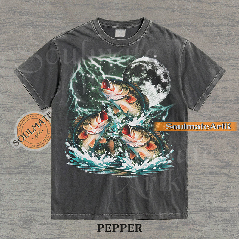 Collage of three bass fish jumping out of water in front of a glowing moon and lightning on a washed pepper shirt.