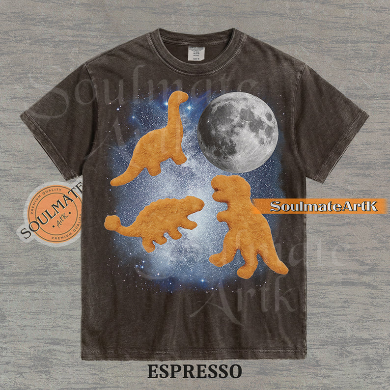 Vintage-style graphic of three golden dinosaur nuggets floating in a blue space nebula with a large moon on a washed espresso t-shirt.