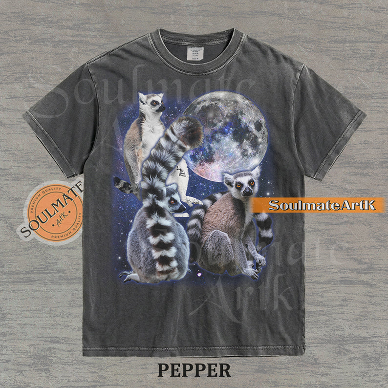 Collage of ring-tailed lemurs in various poses in front of a glowing full moon and a starry nebula on a washed pepper shirt.